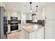 Bright kitchen featuring stainless appliances, tile backsplash and granite countertops at 478 Chicago Woods Cir, Orlando, FL 32824