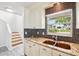 Kitchen with a stainless sink, granite counters, and white cabinets at 478 Chicago Woods Cir, Orlando, FL 32824