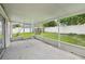Enclosed lanai features a concrete slab floor and views of the fenced yard with green grass at 478 Chicago Woods Cir, Orlando, FL 32824