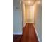 Hallway with hardwood floors and built in storage cabinet with white doors at 4830 S Conway Rd # 40, Orlando, FL 32812