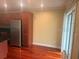 Open kitchen with stainless steel refrigerator and wood floors at 4830 S Conway Rd # 40, Orlando, FL 32812