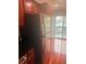 Stainless steel refrigerator next to a sliding glass door and cherry wood cabinets at 4830 S Conway Rd # 40, Orlando, FL 32812