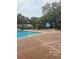 Community pool with a blue umbrella at 4830 S Conway Rd # 40, Orlando, FL 32812