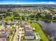 Beautiful aerial view of a neighborhood with ponds, green spaces, and well-maintained homes, near city at 4993 Southlawn Ave, Orlando, FL 32811