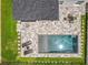 Overhead view of a sparkling pool with lounge chairs in backyard surrounded by green grass at 4993 Southlawn Ave, Orlando, FL 32811