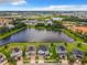 Overhead view of homes nestled by a tranquil lake, showcasing lush greenery and neighborhood charm at 4993 Southlawn Ave, Orlando, FL 32811