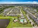 Aerial view of a well-planned community featuring homes, lakes, and a community pool with recreation area at 4993 Southlawn Ave, Orlando, FL 32811