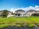 A home with a spacious backyard with a view of the pond, black metal fence and white vinyl fence at 4993 Southlawn Ave, Orlando, FL 32811