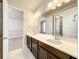 Bathroom featuring a dual sink vanity with modern lighting fixtures and tiled flooring, for shared use at 4993 Southlawn Ave, Orlando, FL 32811