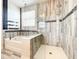 Bathroom featuring separate tub and glass-enclosed shower with stylish tile work at 4993 Southlawn Ave, Orlando, FL 32811