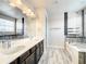 Double vanity bathroom with a large mirror and a soaking tub with glass door at 4993 Southlawn Ave, Orlando, FL 32811