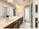 Bathroom featuring a dual sink vanity with modern lighting fixtures and tiled flooring, for shared use at 4993 Southlawn Ave, Orlando, FL 32811