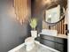 Stylish powder room with modern vanity, decorative mirror, and elegant fixtures at 4993 Southlawn Ave, Orlando, FL 32811
