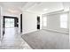 Spacious bedroom with plush carpeting and natural light, transitioning into another room at 4993 Southlawn Ave, Orlando, FL 32811