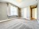 Bedroom featuring a cozy carpet, a bright window, and a closet for ample storage to match any decor at 4993 Southlawn Ave, Orlando, FL 32811
