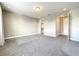 Large bedroom with carpet flooring, neutral walls, and entrances to a closet and another room at 4993 Southlawn Ave, Orlando, FL 32811