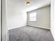 Bright bedroom featuring neutral paint, carpet flooring, a window, and modern lighting at 4993 Southlawn Ave, Orlando, FL 32811