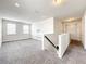 Bright bonus room featuring a decorative accent wall and plush carpeting, ideal for a play or media space at 4993 Southlawn Ave, Orlando, FL 32811