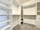 Large walk-in closet with custom shelving, drawers, and hanging rods for ample storage at 4993 Southlawn Ave, Orlando, FL 32811