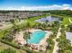 Aerial view of the community pool, including lounge chairs, lake view, and playground at 4993 Southlawn Ave, Orlando, FL 32811