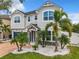 Inviting two-story home with well-manicured front yard, featuring lush landscaping and a stone-accented entrance at 4993 Southlawn Ave, Orlando, FL 32811