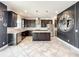Modern kitchen with stainless steel appliances, a center island, dark cabinets, and stylish backsplash at 4993 Southlawn Ave, Orlando, FL 32811