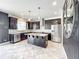 Modern kitchen with stainless steel appliances, a center island, dark cabinets, and stylish backsplash at 4993 Southlawn Ave, Orlando, FL 32811