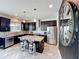 Beautiful kitchen featuring dark wood cabinets, granite countertops, stainless steel appliances, and a center island with seating at 4993 Southlawn Ave, Orlando, FL 32811