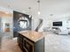 Inviting kitchen with central island and view to the living area at 4993 Southlawn Ave, Orlando, FL 32811