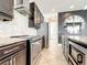 Modern kitchen featuring stainless steel appliances, granite countertops, and dark wood cabinetry at 4993 Southlawn Ave, Orlando, FL 32811