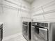 Clean laundry room featuring a modern washer and dryer set and ample wire shelving for storage at 4993 Southlawn Ave, Orlando, FL 32811