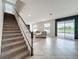 Living room and stairs area with accent wall and an inviting indoor/outdoor living space at 4993 Southlawn Ave, Orlando, FL 32811