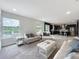 Comfortable living room with water view, and open to the kitchen featuring stainless appliances at 4993 Southlawn Ave, Orlando, FL 32811