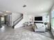 Bright, open-concept living room with modern fireplace, large windows, and neutral tones at 4993 Southlawn Ave, Orlando, FL 32811