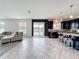 Spacious living room with tile floors, comfortable seating, and a view of the lake through the sliding glass doors at 4993 Southlawn Ave, Orlando, FL 32811