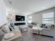 Bright living room with a fireplace, large windows overlooking the lake, and neutral tones at 4993 Southlawn Ave, Orlando, FL 32811