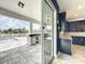 Modern outdoor kitchen with view of pool and lake at 4993 Southlawn Ave, Orlando, FL 32811