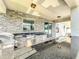Elegant outdoor kitchen with stone facade, stainless steel appliances, and granite countertops for perfect entertaining at 4993 Southlawn Ave, Orlando, FL 32811