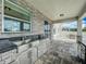 Outdoor kitchen with stainless steel sink and granite counter tops overlooking the outdoor seating area at 4993 Southlawn Ave, Orlando, FL 32811