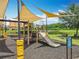 The community playground offers shade, a slide, swings, and a beautiful view of a pond at 4993 Southlawn Ave, Orlando, FL 32811