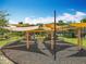 Community playground with shade coverings, swings, spring riders, and benches at 4993 Southlawn Ave, Orlando, FL 32811