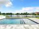Stunning pool overlooking a serene lake view, complete with a paved deck and black aluminum safety fence at 4993 Southlawn Ave, Orlando, FL 32811