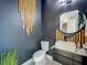 Stylish powder room with dark walls, modern vanity, and unique mirror at 4993 Southlawn Ave, Orlando, FL 32811