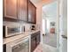 Charming wet bar with granite counters, tile backsplash, and stainless steel appliances at 4993 Southlawn Ave, Orlando, FL 32811