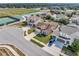 Aerial view of the home with well-manicured landscaping and a two-car garage at 5018 Tupelo Ct, Minneola, FL 34715