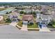 Aerial view of a well-maintained home with a lush front yard and a two-car garage at 5018 Tupelo Ct, Minneola, FL 34715