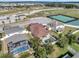 Aerial view of the home with a pool in the fenced-in backyard and community amenities nearby at 5018 Tupelo Ct, Minneola, FL 34715