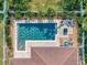 Aerial view of a backyard pool and patio area with a well-maintained lawn and landscaping at 5018 Tupelo Ct, Minneola, FL 34715
