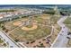 Aerial view of a baseball field complex with multiple baseball diamonds and recreational facilities at 5018 Tupelo Ct, Minneola, FL 34715