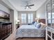 Bedroom with a ceiling fan, shutters, and a television set on top of wooden drawers at 5018 Tupelo Ct, Minneola, FL 34715